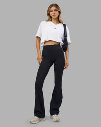 Woman wearing Go-To V-Neck FLXCotton Oversized Tee - White-Black | Model:Leilani | Size:XS