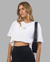 Woman wearing Go-To V-Neck FLXCotton Oversized Tee - White-Black | Model:Leilani | Size:XS
