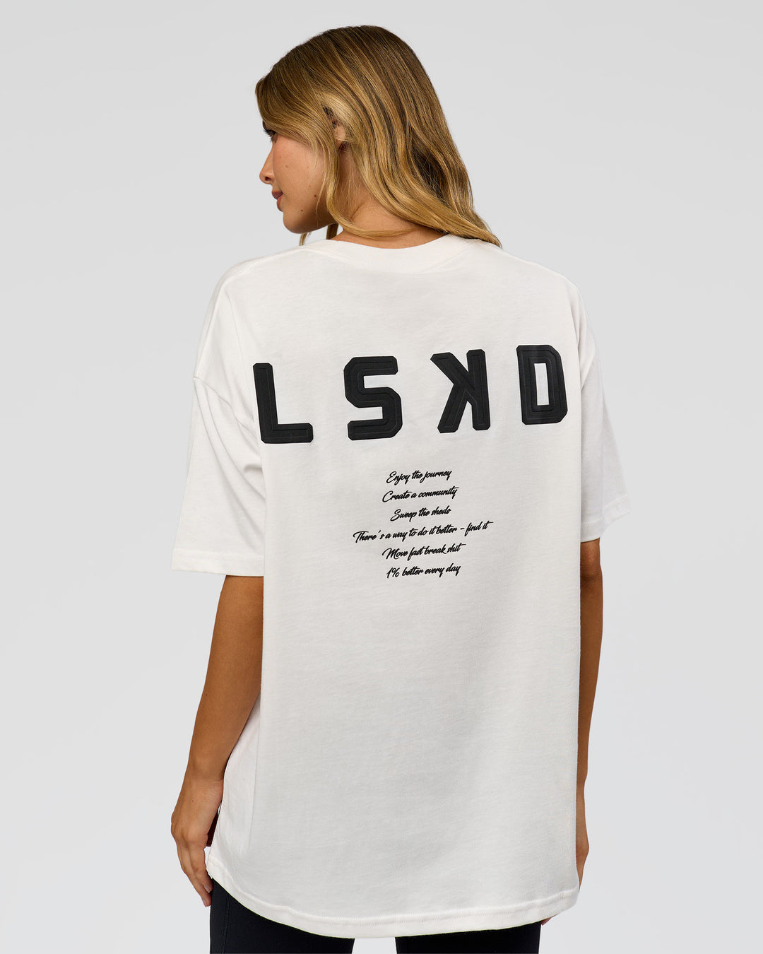 Woman wearing Hype Heavyweight Unisex Oversized Tee - Off White-Black | Model:Leilani | Size:XS