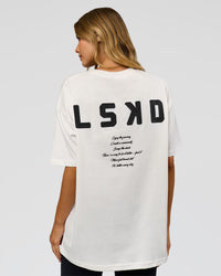 Woman wearing Hype Heavyweight Unisex Oversized Tee - Off White-Black | Model:Leilani | Size:XS