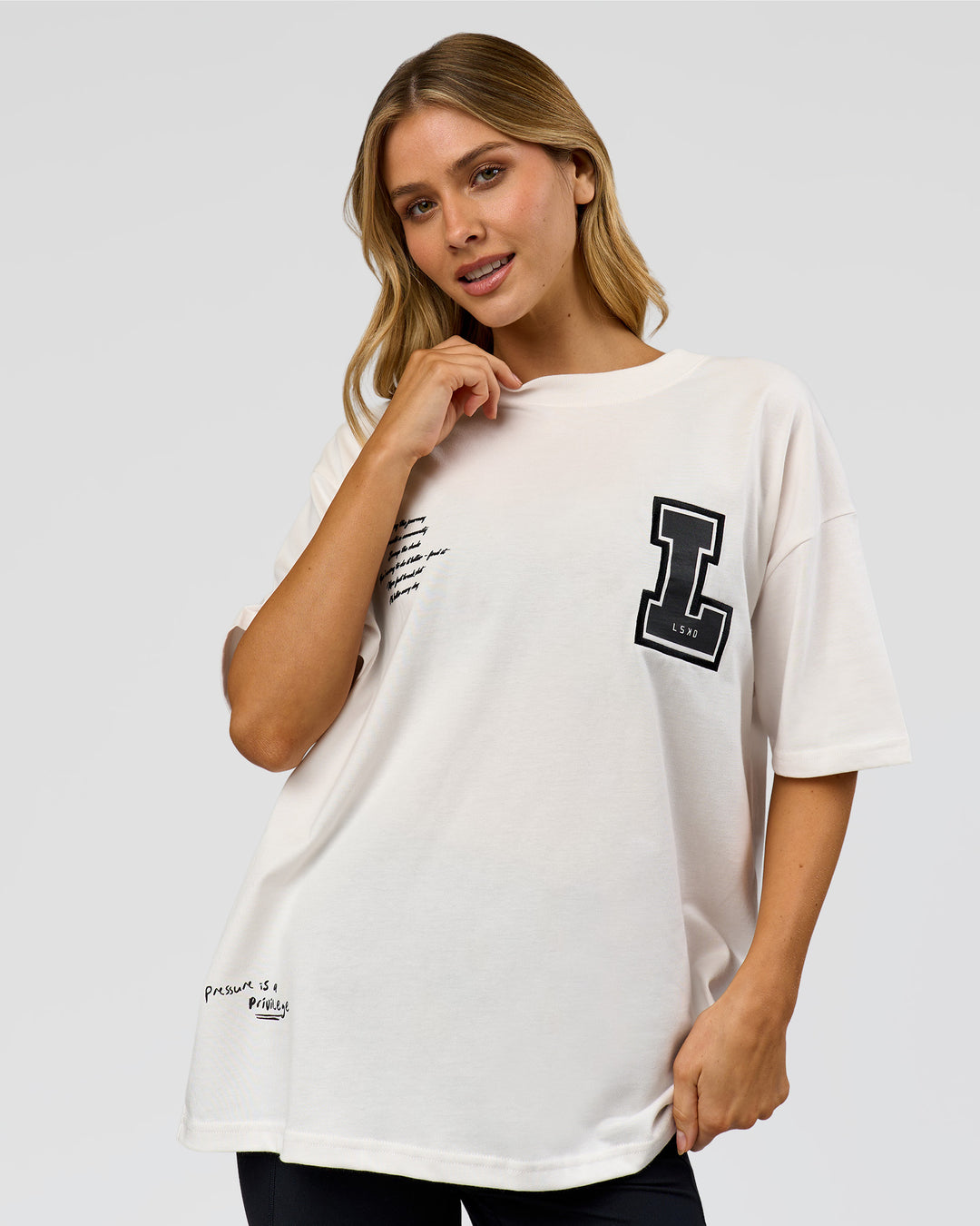 Woman wearing Hype Heavyweight Unisex Oversized Tee - Off White-Black | Model:Leilani | Size:XS