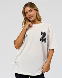Woman wearing Hype Heavyweight Unisex Oversized Tee - Off White-Black | Model:Leilani | Size:XS