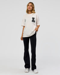 Woman wearing Hype Heavyweight Unisex Oversized Tee - Off White-Black | Model:Leilani | Size:XS