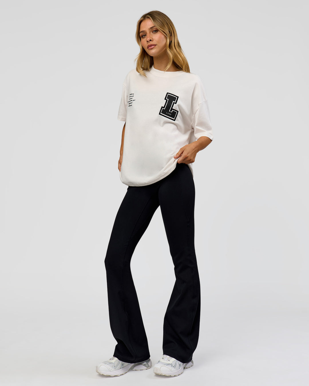 Woman wearing Hype Heavyweight Unisex Oversized Tee - Off White-Black | Model:Leilani | Size:XS