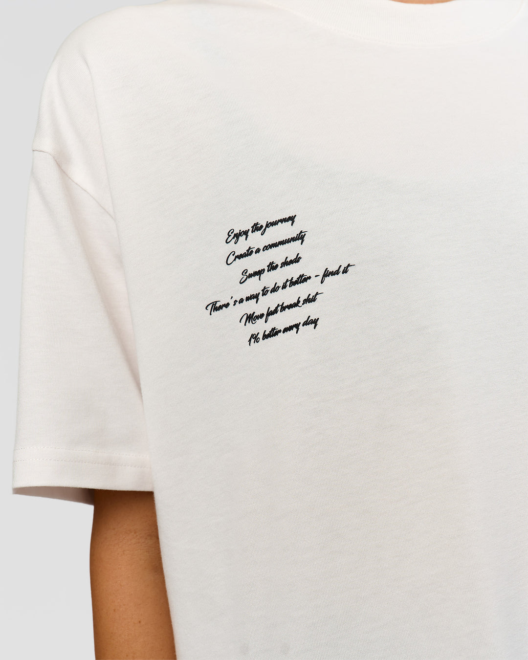 Woman wearing Hype Heavyweight Unisex Oversized Tee - Off White-Black | Model:Leilani | Size:XS