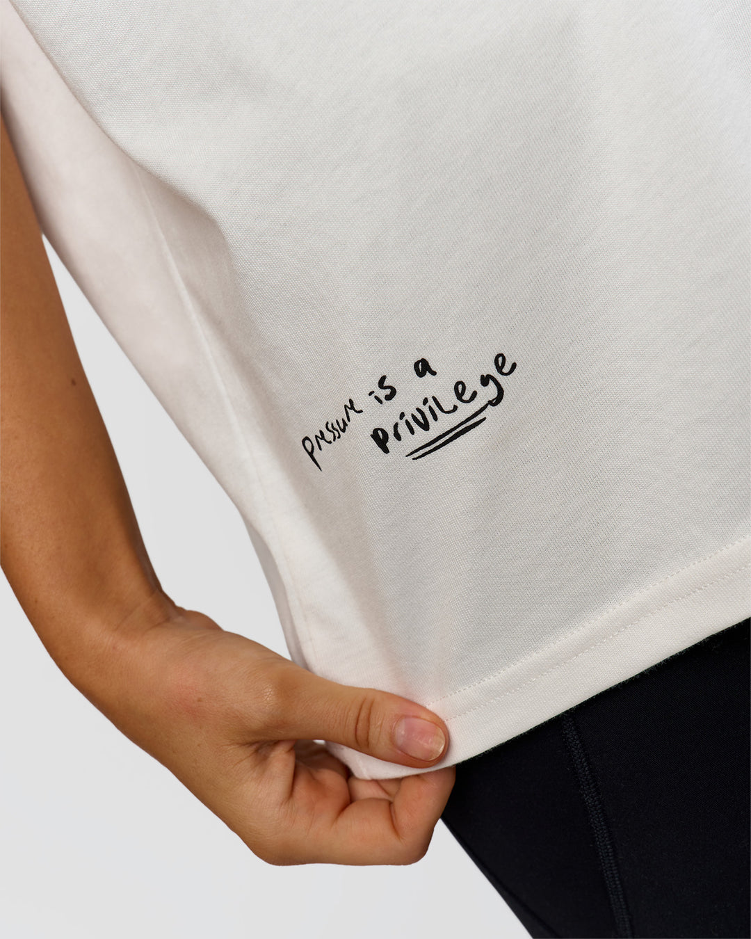Woman wearing Hype Heavyweight Unisex Oversized Tee - Off White-Black | Model:Leilani | Size:XS