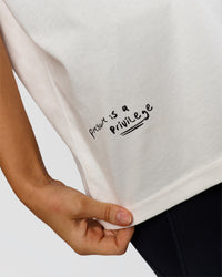 Woman wearing Hype Heavyweight Unisex Oversized Tee - Off White-Black | Model:Leilani | Size:XS