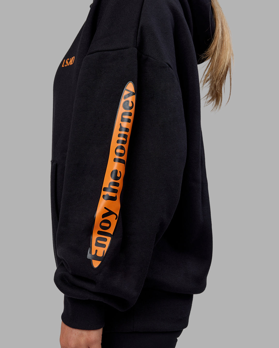 Woman wearing Hyped Unisex Oversized Hoodie - Black-Vibrant Orange | Model:Neve | Size:XS