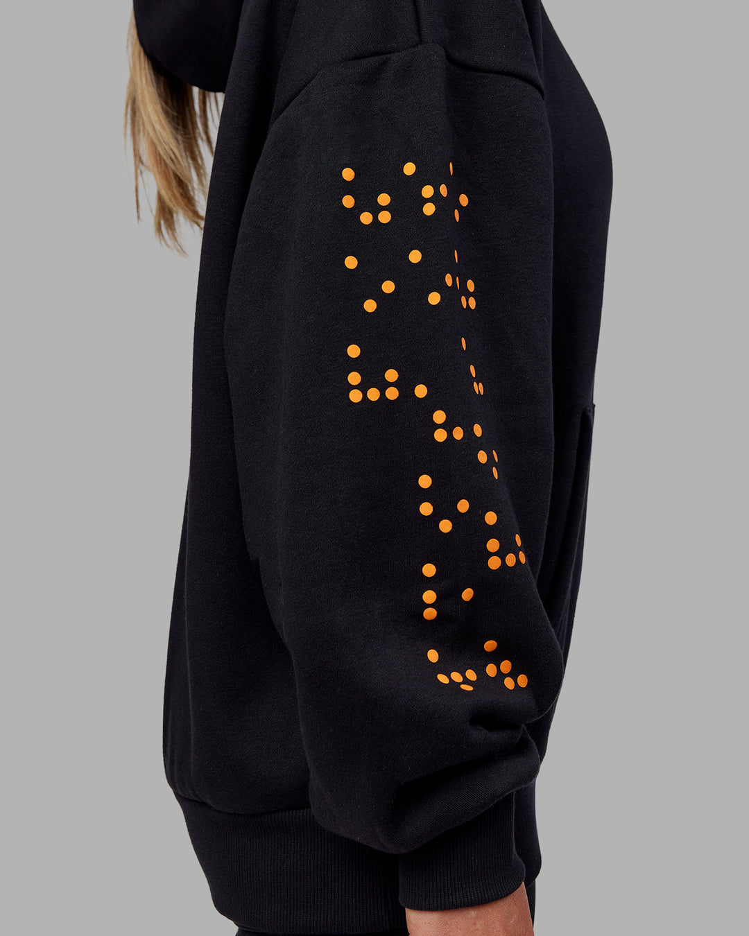 Woman wearing Hyped Unisex Oversized Hoodie - Black-Vibrant Orange | Model:Neve | Size:XS