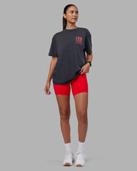 Woman wearing Inferno Journey FLXCotton Oversized Tee - Black Washed-Ultra Orange | Model:Rhiley | Size:XS