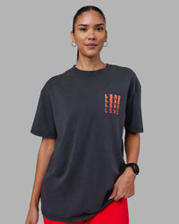Woman wearing Inferno Journey FLXCotton Oversized Tee - Black Washed-Ultra Orange | Model:Rhiley | Size:XS