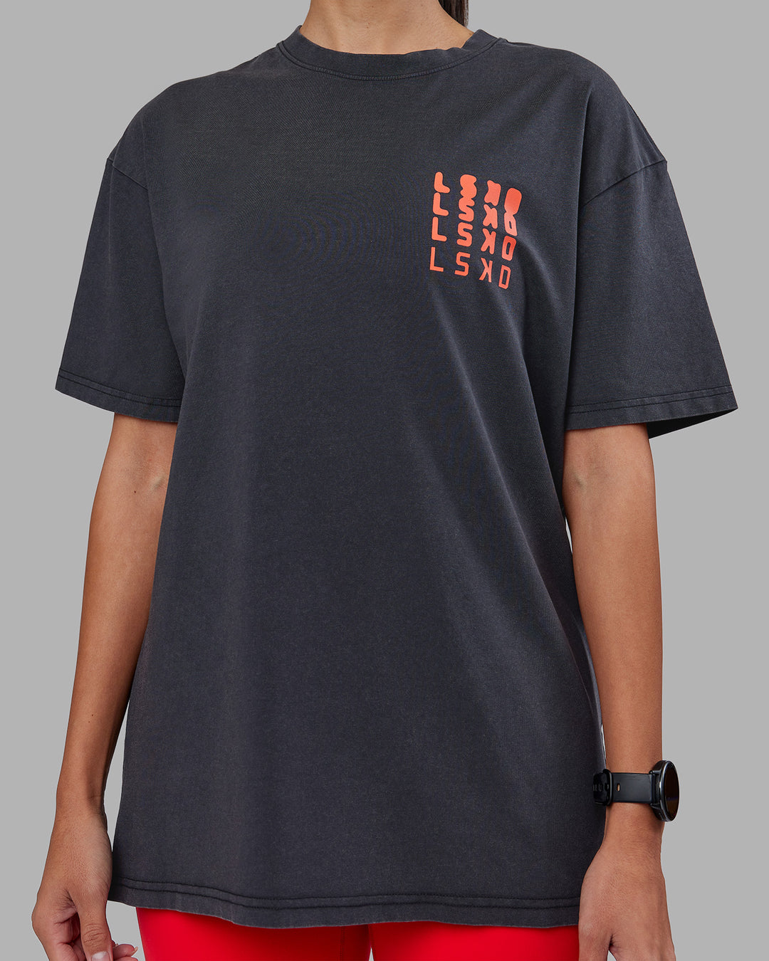 Woman wearing Inferno Journey FLXCotton Oversized Tee - Black Washed-Ultra Orange | Model:Rhiley | Size:XS