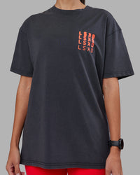 Woman wearing Inferno Journey FLXCotton Oversized Tee - Black Washed-Ultra Orange | Model:Rhiley | Size:XS