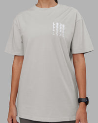 Woman wearing Inferno Journey FLXCotton Oversized Tee - Digital Mist Washed-White | Model:Rhiley | Size:XS