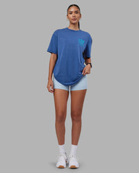 Woman wearing Inferno Journey FLXCotton Oversized Tee - Midnight Blue Washed-Blue | Model:Rhiley | Size:XS