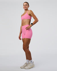 Woman wearing Interstellar Sports Bra - Candy Pink | Model:Emelia | Size:XS