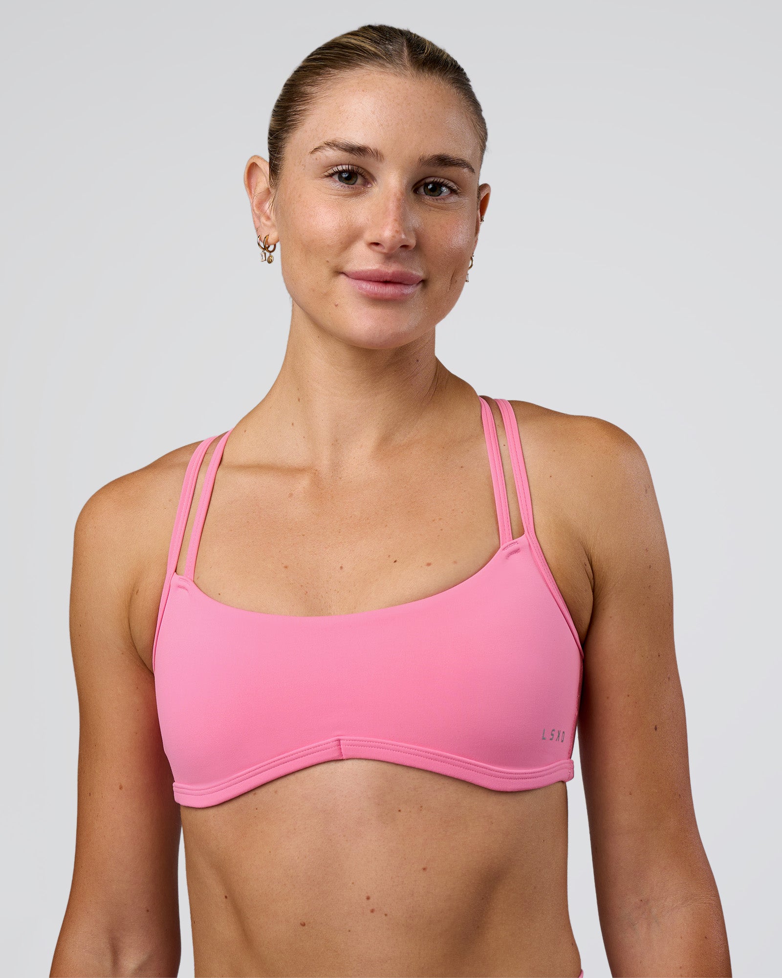 Woman wearing Interstellar Sports Bra - Candy Pink | Model:Emelia | Size:XS
