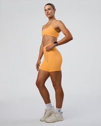 Woman wearing Interstellar Sports Bra - Warm Apricot | Model:Emelia | Size:XS