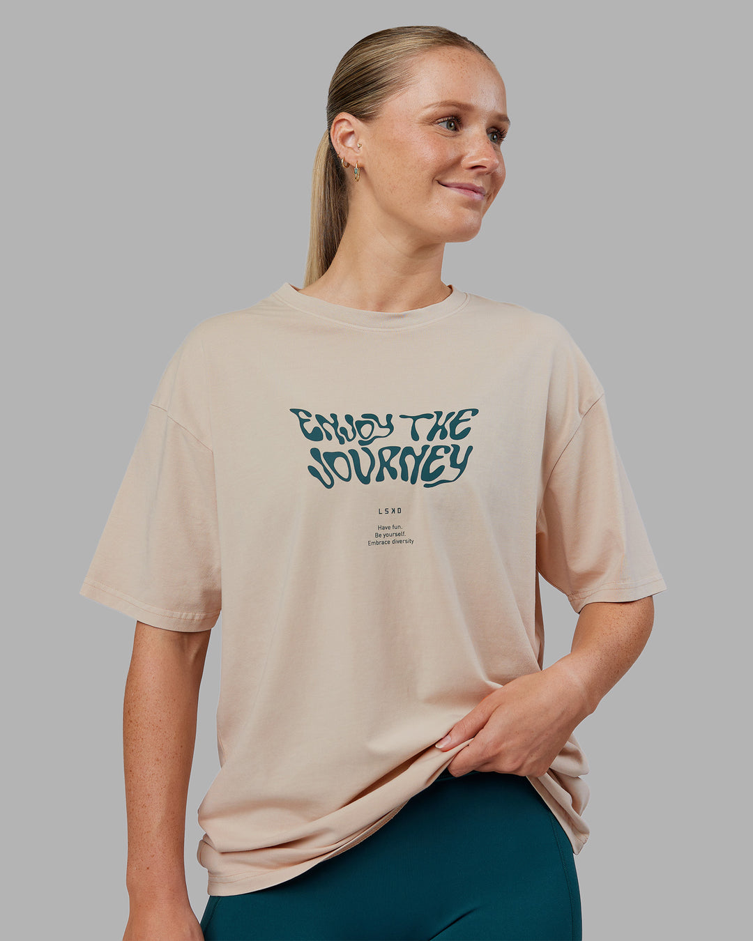 Woman wearing Journey FLXCotton Oversized Tee - Washed Shale Beige-Dark Moss| Model:Neve | Size:XS