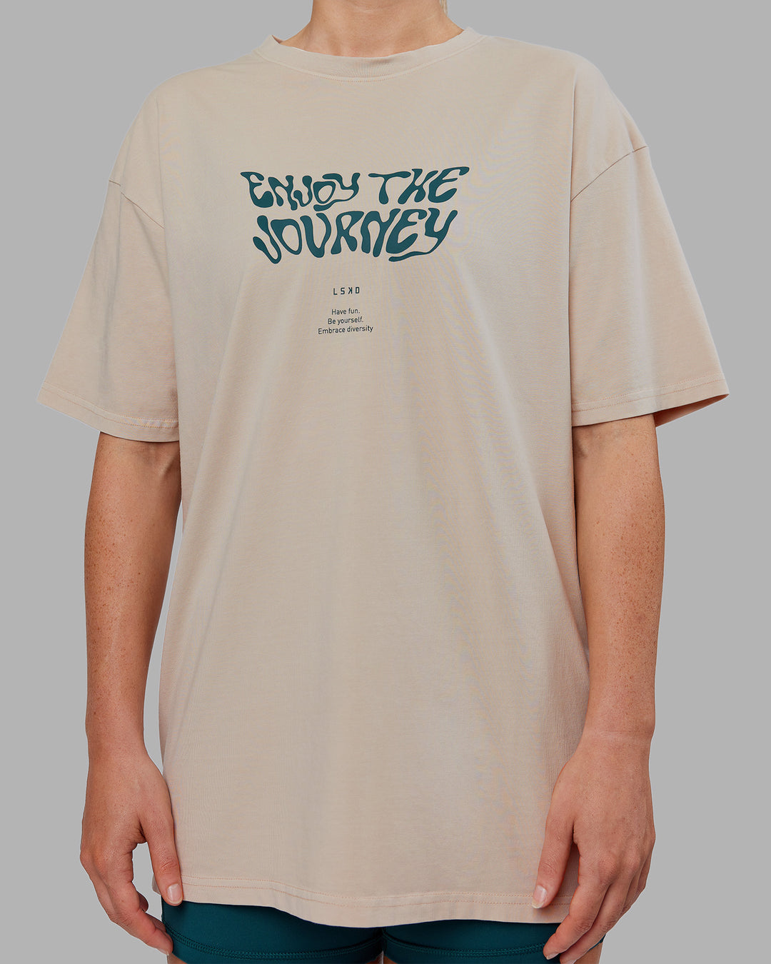 Woman wearing Journey FLXCotton Oversized Tee - Washed Shale Beige-Dark Moss| Model:Neve | Size:XS