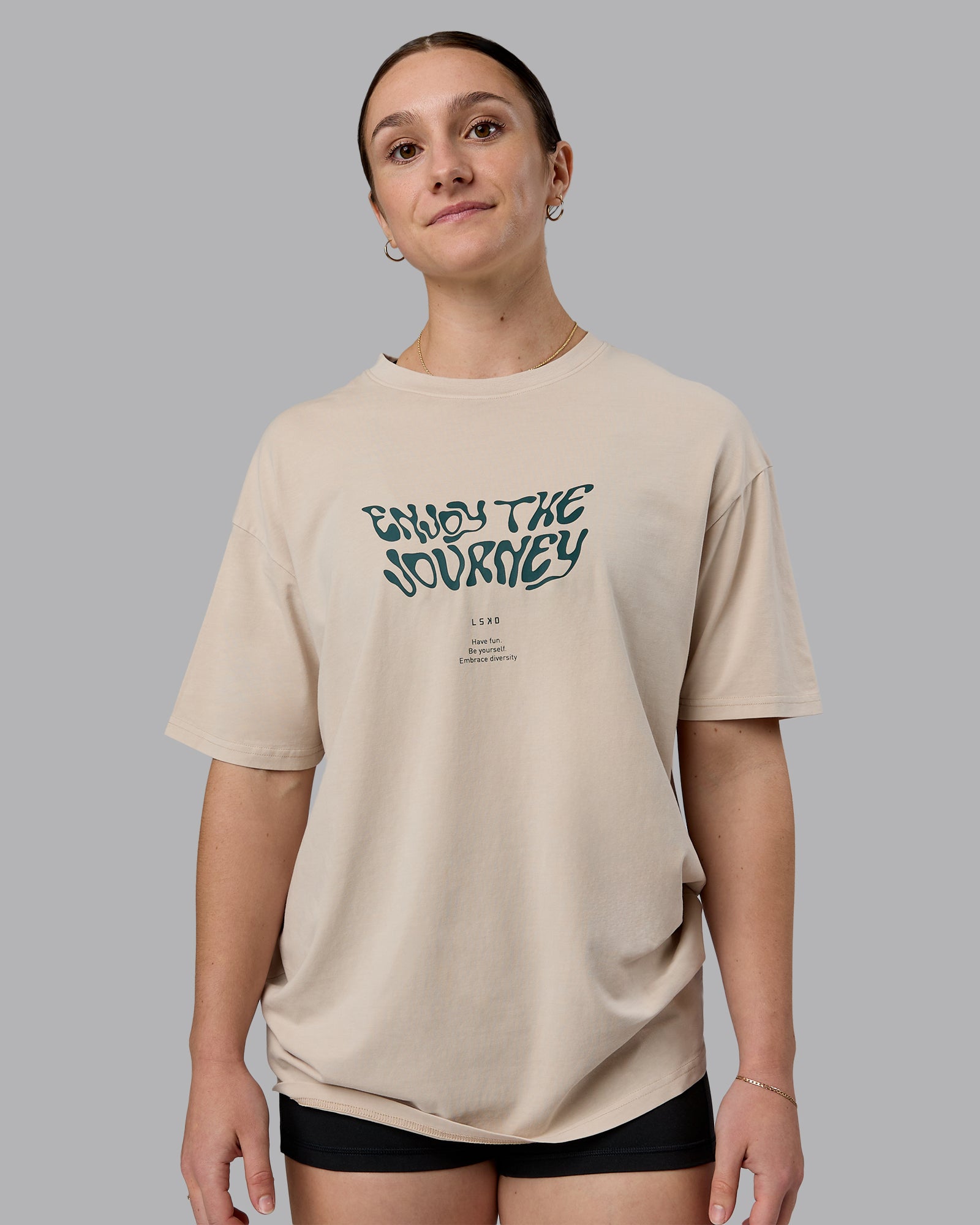 Woman wearing Journey FLXCotton Oversized Tee in Washed Shale-Beige Dark-Moss | Model:Sav | Size:XS