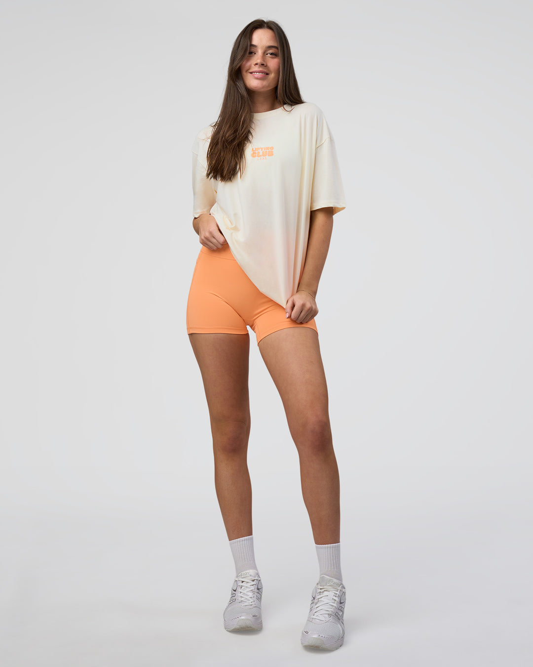 Woman wearing Kettle B FLXCotton Oversized Tee - Sugar Swizzle-Cantaloupe | Model:Estella | Size:XS