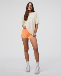 Woman wearing Kettle B FLXCotton Oversized Tee - Sugar Swizzle-Cantaloupe | Model:Estella | Size:XS