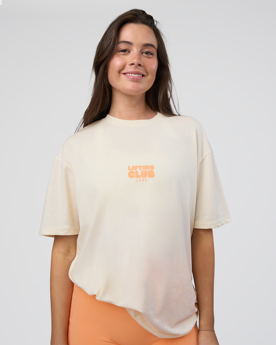 Woman wearing Kettle B FLXCotton Oversized Tee - Sugar Swizzle-Cantaloupe | Model:Estella | Size:XS