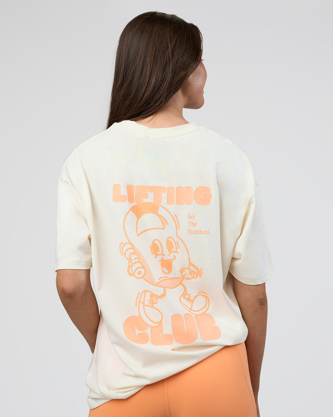 Woman wearing Kettle B FLXCotton Oversized Tee - Sugar Swizzle-Cantaloupe | Model:Estella | Size:XS