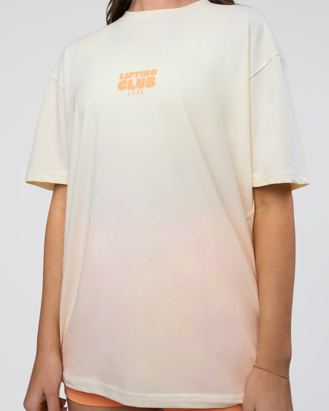 Woman wearing Kettle B FLXCotton Oversized Tee - Sugar Swizzle-Cantaloupe | Model:Estella | Size:XS