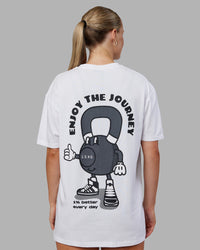 Woman wearing Kettlebell FLXCotton Oversized Tee - White-Black | Model:Neve | Size:XS