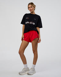 Woman wearing LSKD Run Club FLXCotton Oversized Tee - Black-White | Model:Leilani | Size:XS