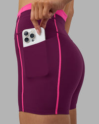 Woman wearing Liberate Contrast High-Rise 4" Short Pockets - Plum Caspia-Ultra Pink | Model:Leilani | Size:XS