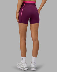 Woman wearing Liberate Contrast High-Rise 4" Short Pockets - Plum Caspia-Ultra Pink | Model:Leilani | Size:XS
