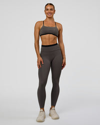 Woman wearing Liberate High-Rise Full Length Legging Pockets in Duskstone-Black | Model:Maja | Size:XS