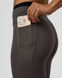 Woman wearing Liberate High-Rise Full Length Legging Pockets in Duskstone-Black | Model:Maja | Size:XS
