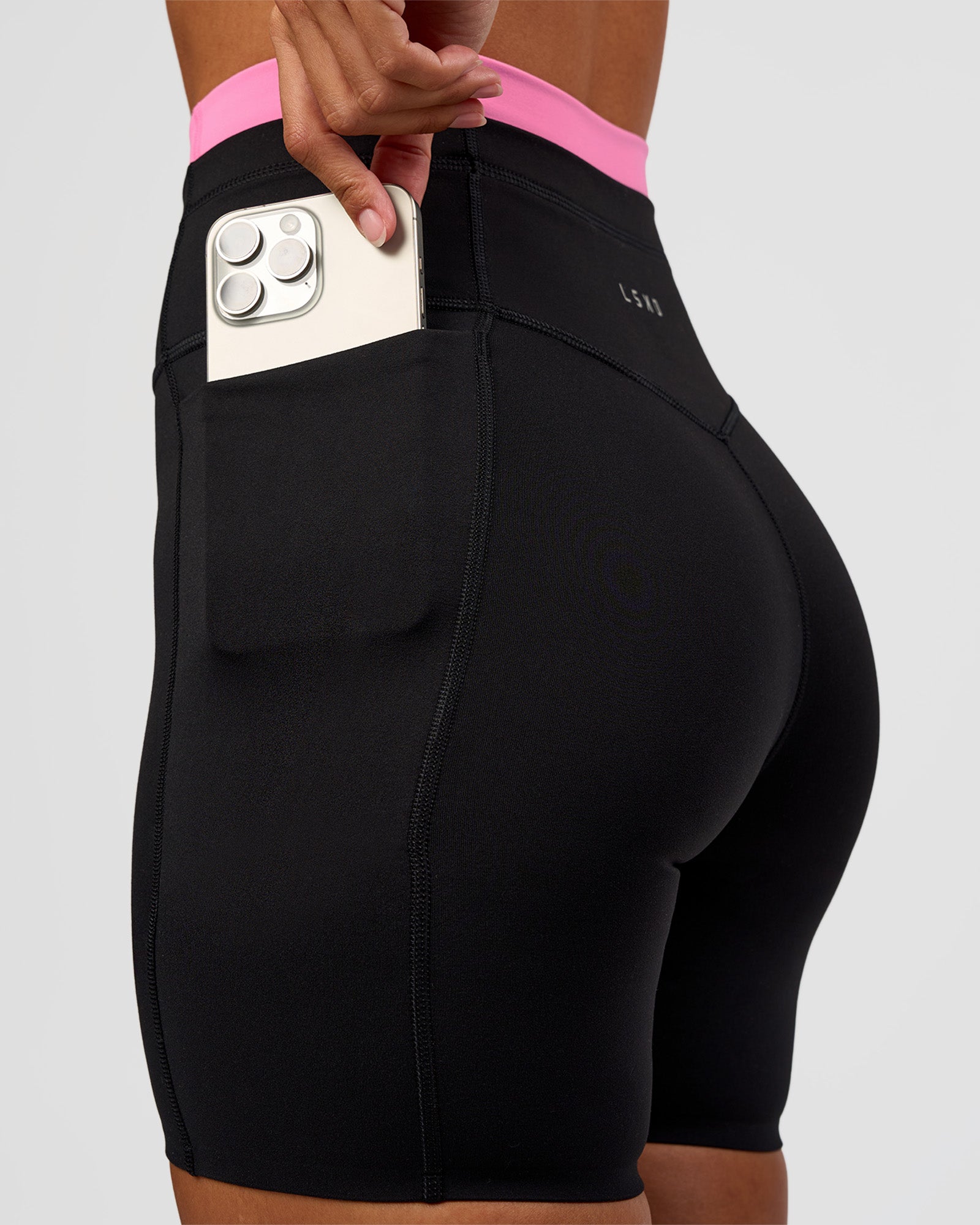 Woman wearing Liberate High-Rise 6" Short Pockets - Black-Candy Pink | Model:Brylee | Size:XS