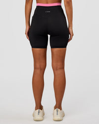Woman wearing Liberate High-Rise 6" Short Pockets - Black-Candy Pink | Model:Brylee | Size:XS | Thumbnail Index: 1