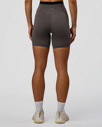 Woman wearing Liberate High-Rise 6" Short Pockets in Duskstone-Black | Model:Maja | Size:XS