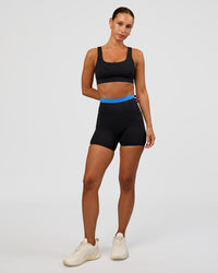 Woman wearing Liberate High-Rise 4" Short Pockets - Black-Palace Blue | Model:Brylee | Size:XS | Thumbnail Index: 2