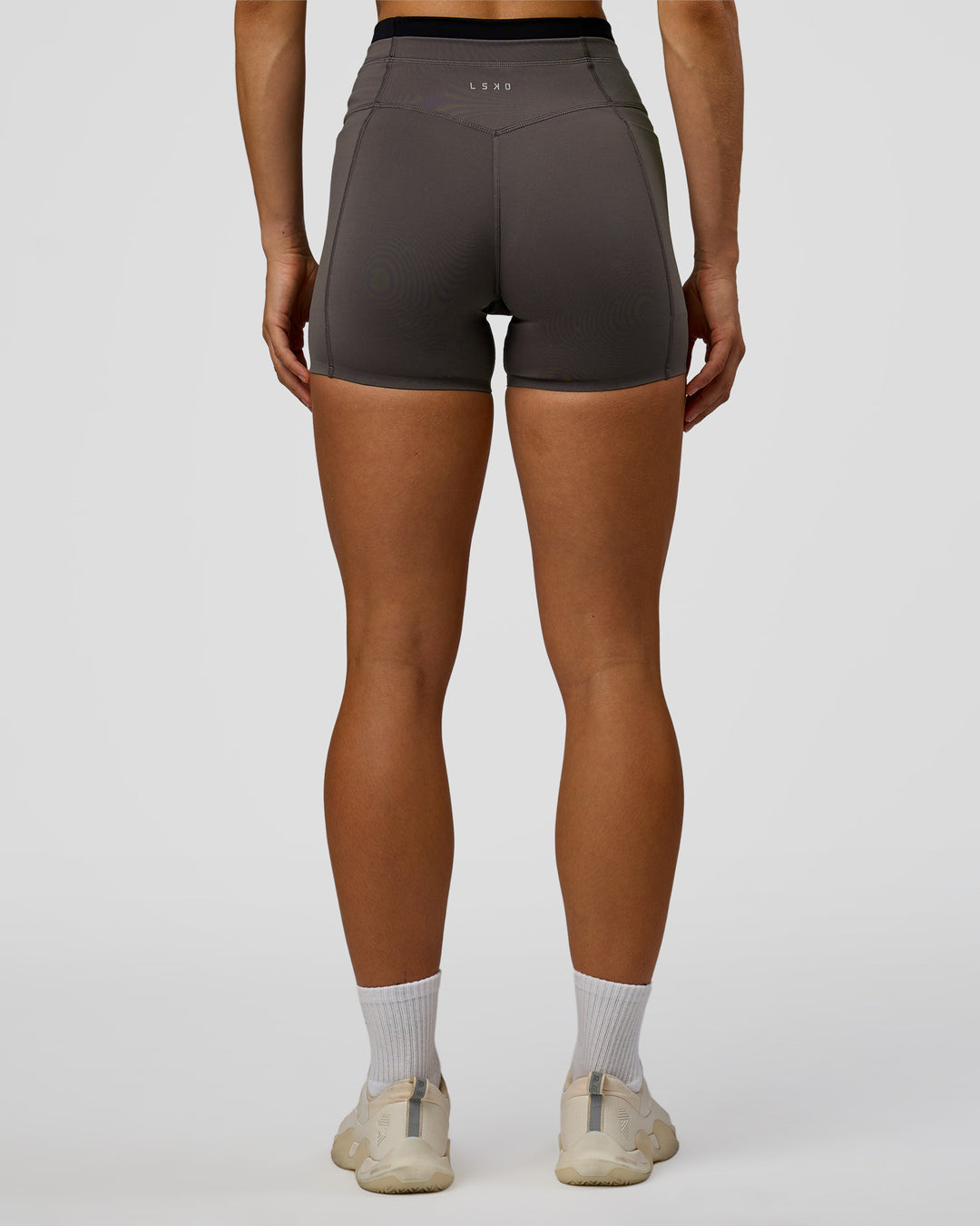Woman wearing Liberate High-Rise 4" Short Pockets in Duskstone-Black | Model:Maja | Size:XS