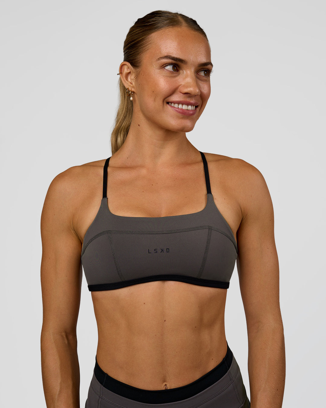 Woman wearing Liberate Sports Bra in Duskstone-Black | Model:Maja | Size:XS
