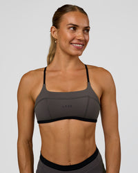 Woman wearing Liberate Sports Bra in Duskstone-Black | Model:Maja | Size:XS