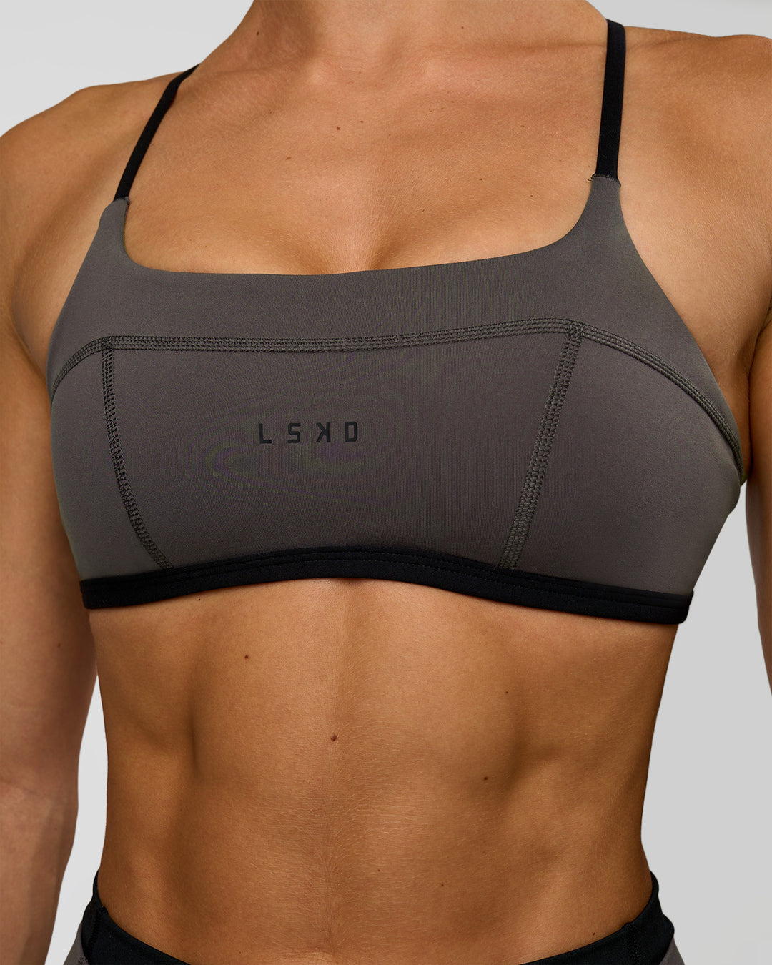 Woman wearing Liberate Sports Bra in Duskstone-Black | Model:Maja | Size:XS