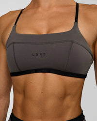 Woman wearing Liberate Sports Bra in Duskstone-Black | Model:Maja | Size:XS
