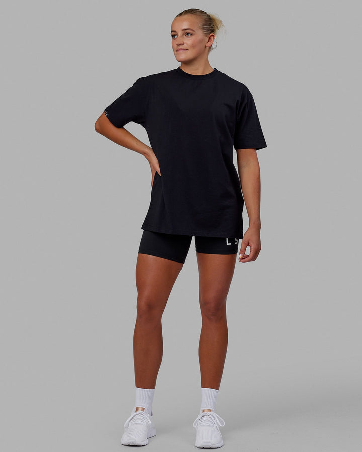 Woman wearing Unisex Lifting Club FLXCotton Tee Oversize - Black-White-Yellow