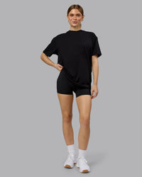 Woman wearing Lifting Club FLXCotton Tee Oversize - Black-Ultra Orange | Model:Emilie | Size:XS