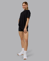 Woman wearing Lifting Club FLXCotton Tee Oversize - Black-Ultra Orange | Model:Emilie | Size:XS