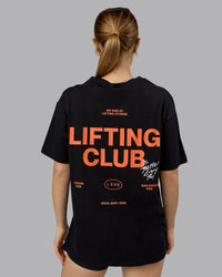 Woman wearing Lifting Club FLXCotton Tee Oversize - Black-Ultra Orange | Model:Emilie | Size:XS