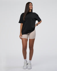 Woman wearing Lifting Club FLXCotton Tee Oversize - Black-Black | Model:Rhiley | Size:XS
